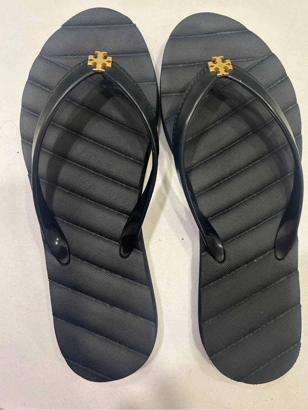 Tory Burch Black Jelly Flip Flops with Gold Emblem.  Worn once, like new!